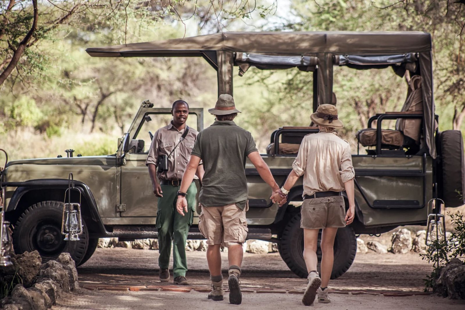 A couple walking to a safari vehicle