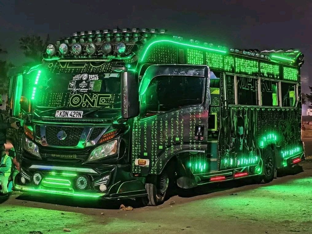 Brightly decorated public transport vehicles on a city street