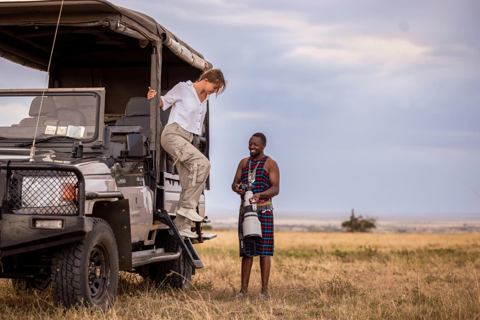 A safari vehicle setting out on an open road at first light